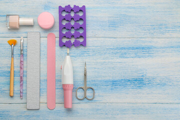 Various tools and things for manicure and pedicure on a blue background. view from above.
