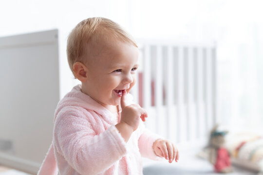 Cute baby girl smiling in her nursery