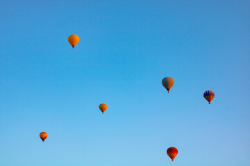 Fototapeta na wymiar Hot air balloons on the sky in the morning. Magical view with hot air balloons.