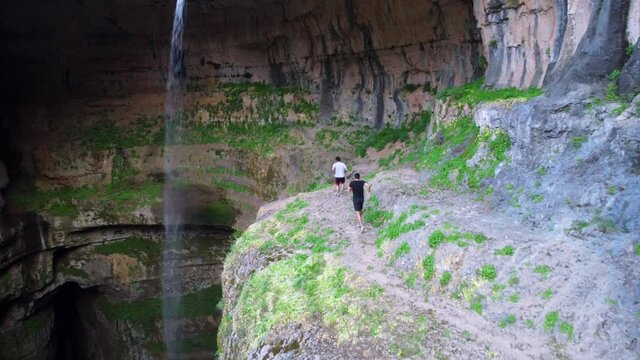 Men Walking On Steep Rugged Cliffs In Baatara Gorge Waterfall Near Balaa In Tannourine, Lebanon. Aerial Drone