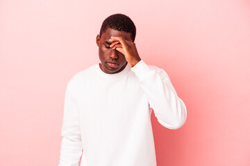 Young African American man isolated on pink background having a head ache, touching front of the face.