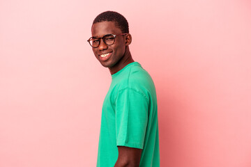 Young African American man isolated on pink background confident keeping hands on hips.