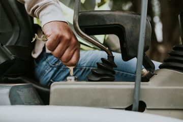 Constructor worker turn a key of a heavy duty vehicle