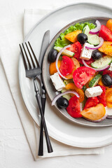 Greek salad with fresh vegetables, feta cheese and black olives. Healthy food. Top view 