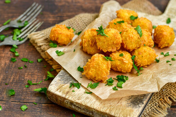 Crispy  deep fried   chicken  nuggets . Breaded  with Cornflakes Breast fillets  with chilly peppers and fresh   basil on wooden rustic background