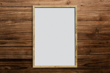 Blank wooden frame on the wooden wall