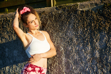 portrait of a young Hispanic woman in sportswear, ready to play sports outdoors.