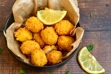 
 Crispy  deep fried   chicken   popcorns  Breaded  with cornflakes chicken  breast fillets  with chilly peppers and fresh   basil on wooden rustic background