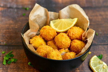
 Crispy  deep fried   chicken   popcorns  Breaded  with cornflakes chicken  breast fillets  with chilly peppers and fresh   basil on wooden rustic background
