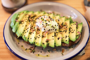 breakfast of avocado toast with egg and coffee with milk