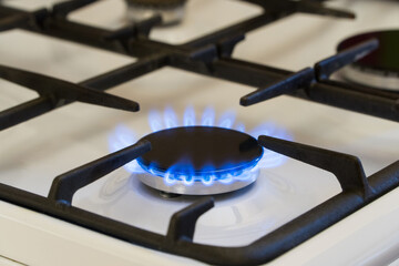 Gas burning in the burner of gas stove, gas shortage and crisis