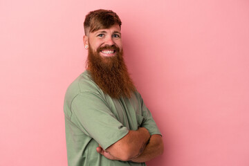 Young caucasian ginger man with long beard isolated on pink background happy, smiling and cheerful.