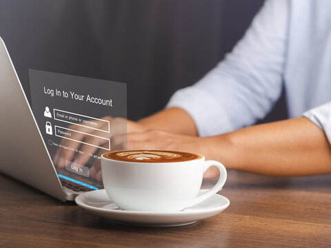 Cyber security concept. The login page on the virtual screen to the computer system on the laptop. A cup of coffee on the table. Business, technology, and networking conceptual