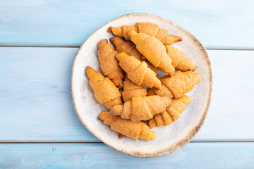 Homemade bagel roll on a blue wooden background and. top view, close up.