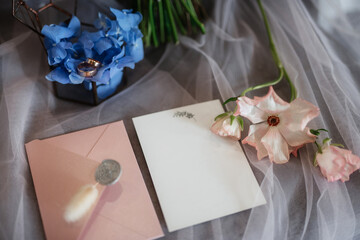 wedding invitation in a gray envelope on a table