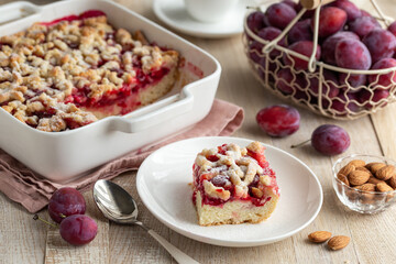 Plum streusel cake in white baking dish
