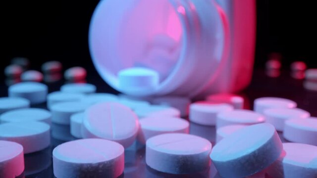 Macro shot of medications pills and tablets spilled out of pill container. Probe lens shot of a Drugs.