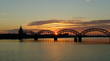 Fototapeta na wymiar Railway bridge in Riga against the background of dawn in autumn.