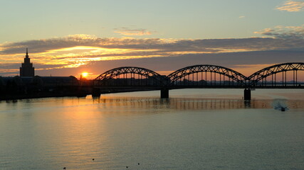 Railway bridge in Riga against the background of dawn in autumn.