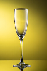 tall champagne glass with highlights on yellow background