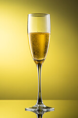 tall champagne glass with highlights on yellow background