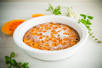 sweet pumpkin pie with pumpkin slices in a ceramic mold