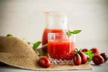 homemade freshly squeezed tomato juice with pulp in a glass decanter