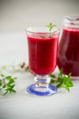 freshly squeezed thick natural juice with pulp from ripe red viburnum in a decanter