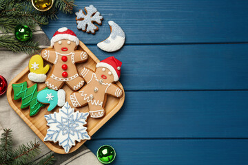 Flat lay composition with delicious Christmas cookies on blue wooden table, space for text