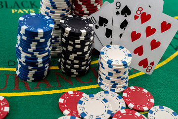 on a green poker table are colored chips on top of each other and cards