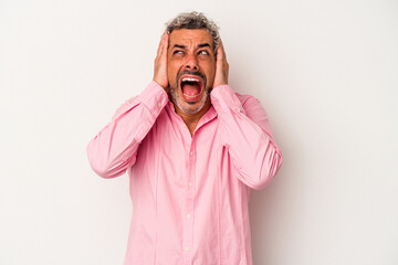 Middle age caucasian man isolated on white background  covering ears with hands trying not to hear too loud sound.