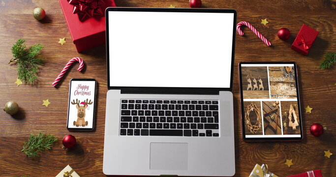 Laptop with copy space on screen, with smartphone,tablet and christmas decorations