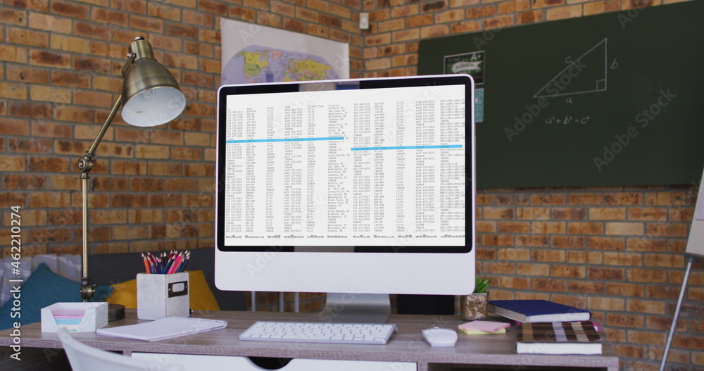 Poster computer screen with data processing standing on desk in office