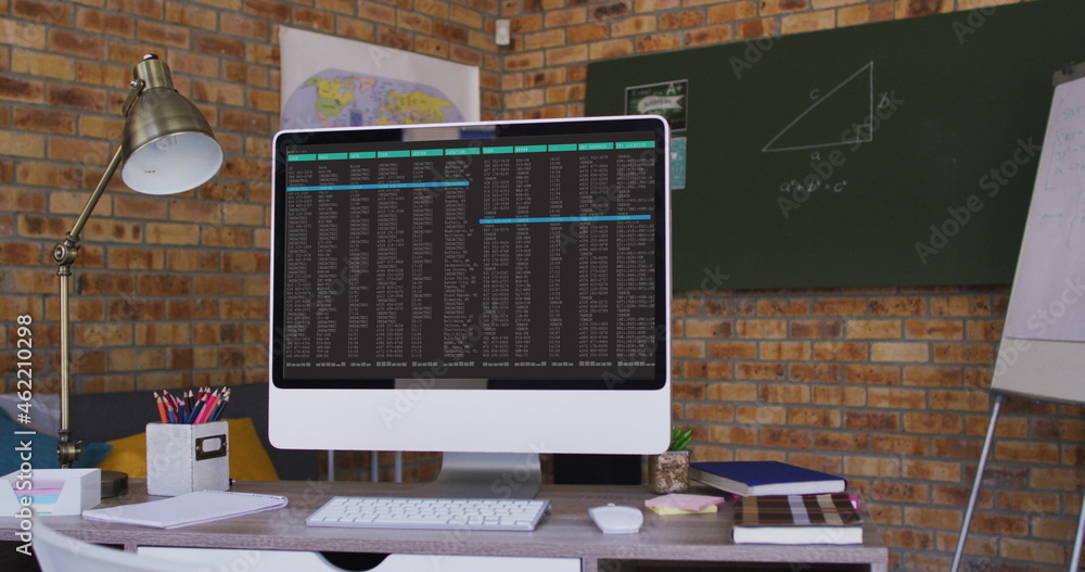 Poster computer screen with data processing standing on desk in office