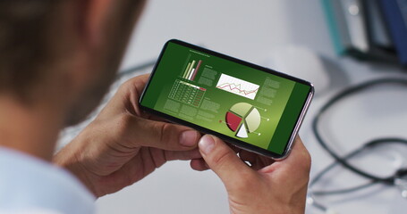 Hands of caucasian man using smartphone with statistics on screen