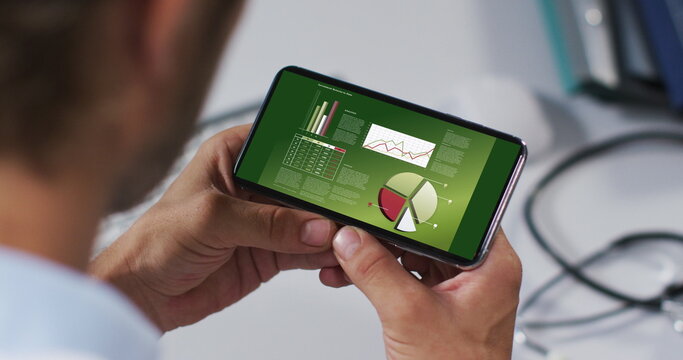 Hands of caucasian man using smartphone with statistics on screen