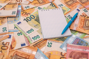 empty notepad memo with pen on euro money