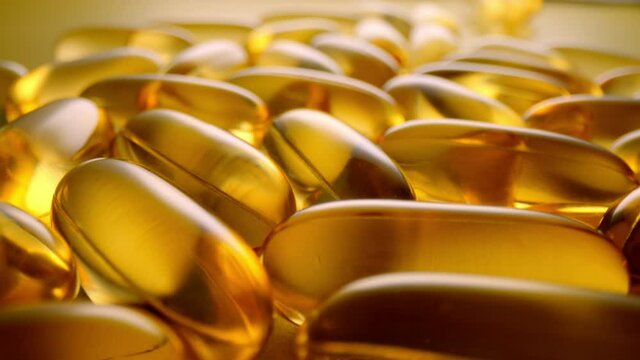 Macro shot of medications pills and tablets. Fish Oil Omega 3 transparent capsules close-up.