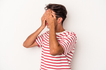 Young mixed race man isolated on white background afraid covering eyes with hands.