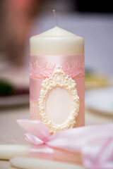 Fototapeta na wymiar Wedding decor in pink style with crystals, lace, flowers and initials. Wedding candles for the family hearth