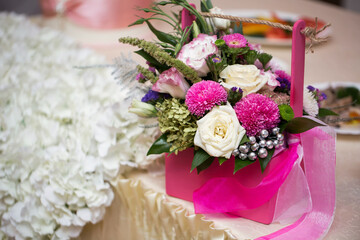 Gift of flowers in a pink basket at a wedding
