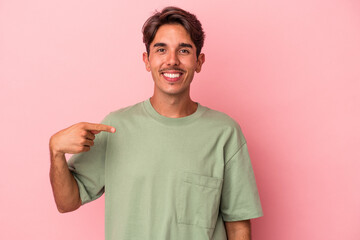 Young mixed race man isolated on white background person pointing by hand to a shirt copy space, proud and confident