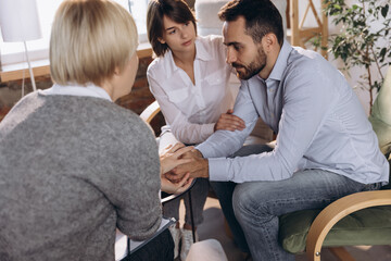 At a psychologist's appointment. Married couple, sad, depressed man and woman meeting with consultant to solve family problem