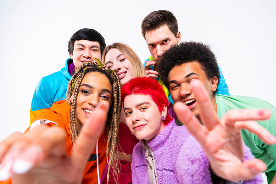 Young man and woman gesturing with friends on white background