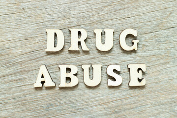 Alphabet letter in word drug abuse on wood background