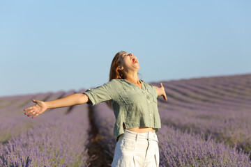 Woman screaming and spreading in a lavender field