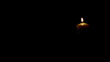 light candle isolated on black background right side of picture