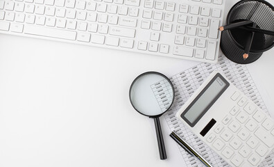 White background with keyboard,chart, calculator, magnifier. Copy space