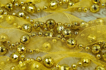 Yellow New Year's and Christmas decorations with beads and ribbon