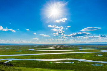 Fototapeta premium Bayinbuluke Grassland and winding river natural scenery in Xinjiang,China.The winding river is on the green grassland.